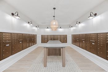 a locker room with wooden lockers and a tableat Oak Grove at Blake Farm, Wilmington, North Carolina